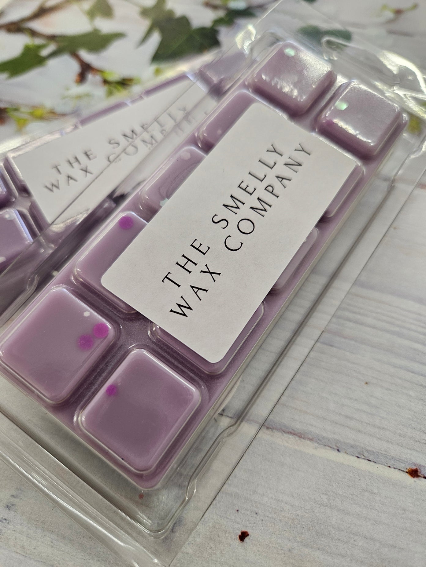 A purple wax melt snapbar in the scent damson plum rose and patchouli by the smelly wax company