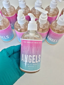 Snow angels hand and body wash in a pink and teal pump bottle by the smelly wax company